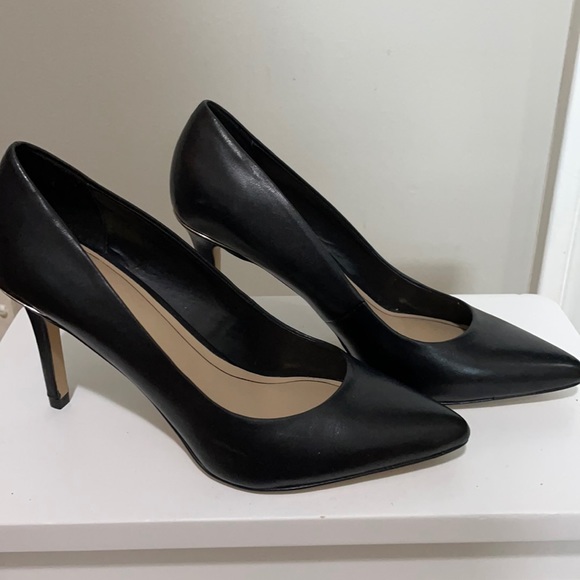 Black Aldo pointy toed heels with gold detail.